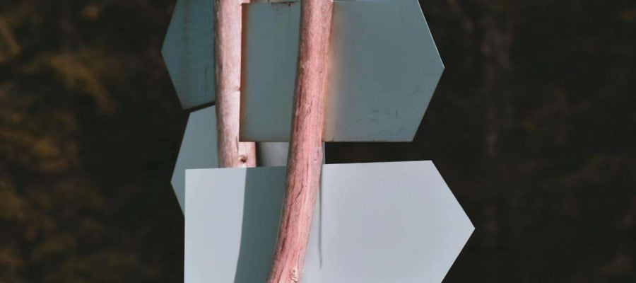 a signpost with arrows pointing in different directions