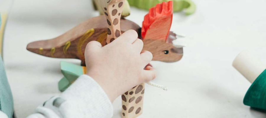 a child sitting on a table playing with toys