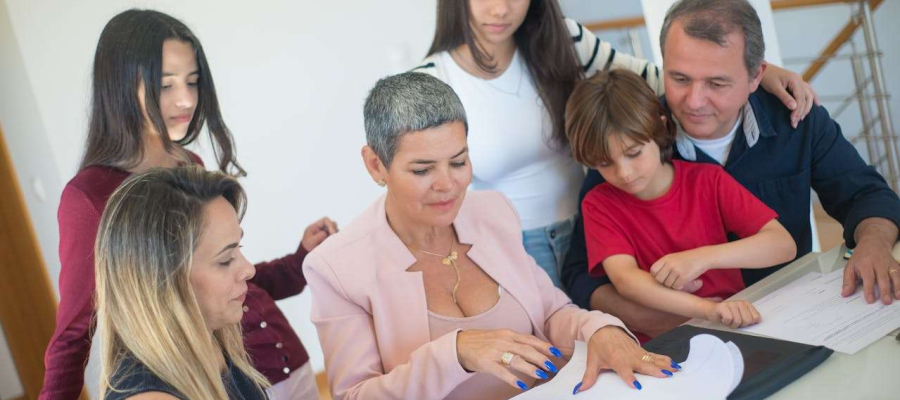 a family including parents, kids and grandparents sitting down and reviewing their estate