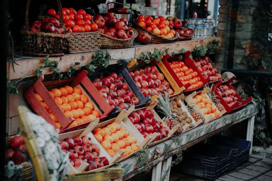 a stand at a store full of fruit