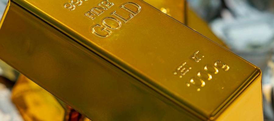 three gold bars on top of money