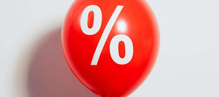 a hand holding a balloon with a percentage symbol