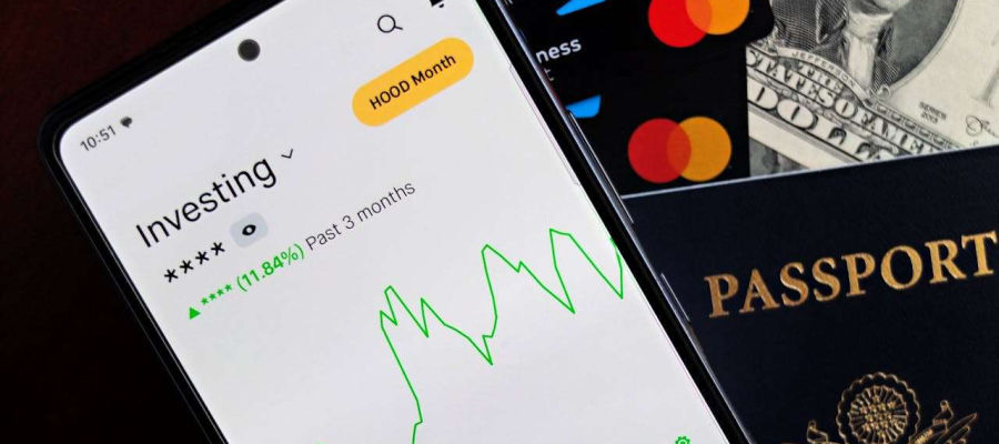 an image showing an investment fluctuating along with debit cards and passports.