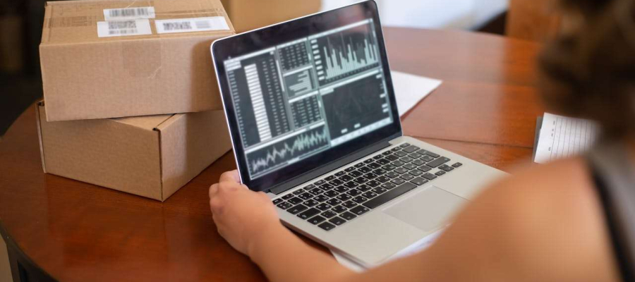 a lady working on a laptop looking at market orders