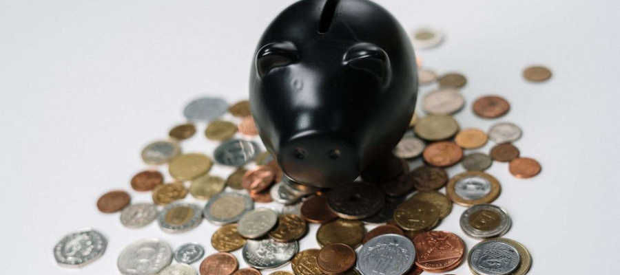 a piggybank with money spread around it
