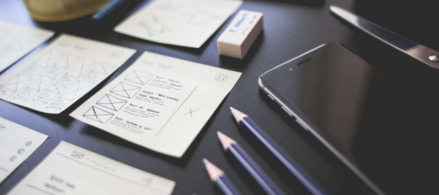 a desk with various notes, pencils and a phone