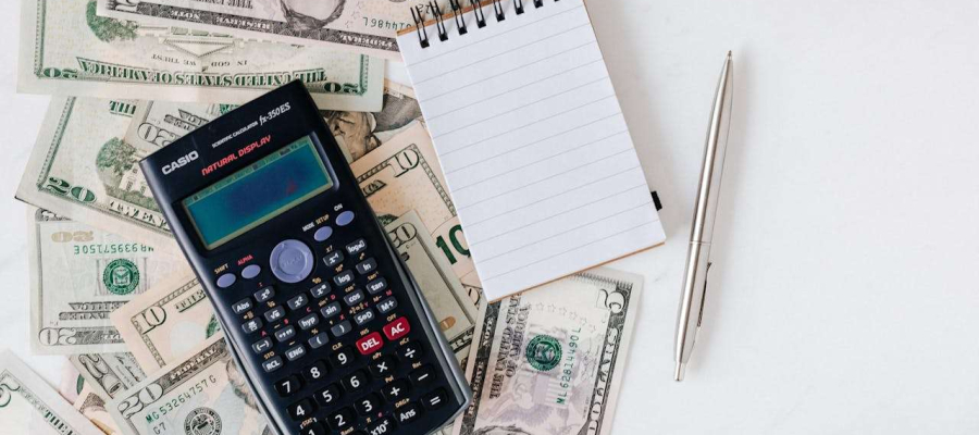 an image displaying paper, pen and money