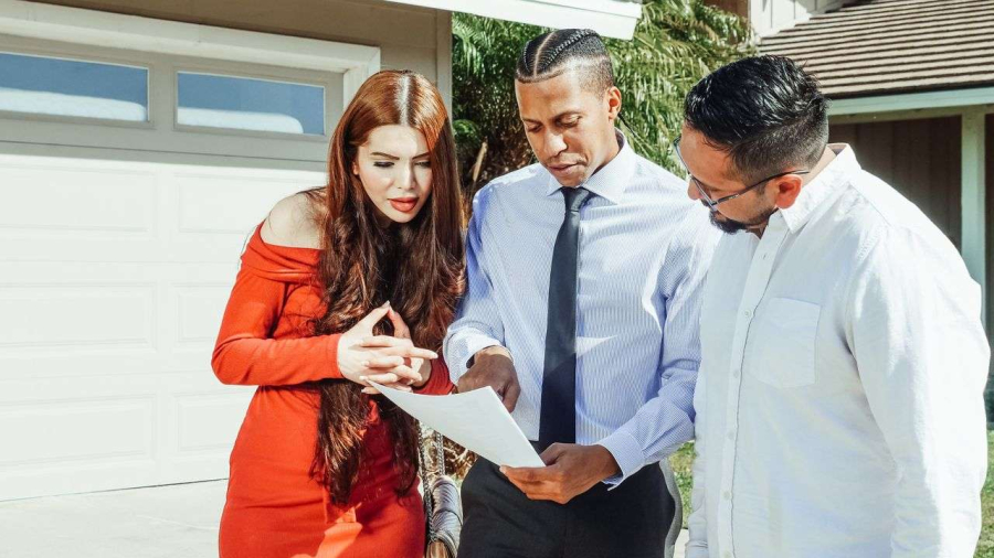 two people discussing rent with a landlord