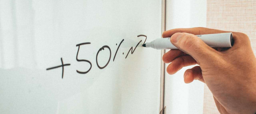 whiteboard with a 50% sum