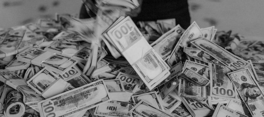 a person tipping out a pile of money