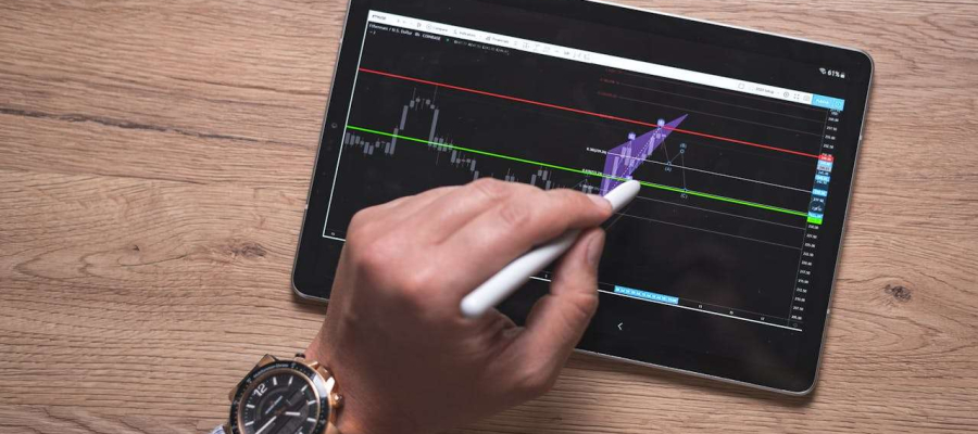 a person using a tablet that shows an investment graph