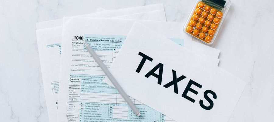 taxes and a calculator on a sheet of papers