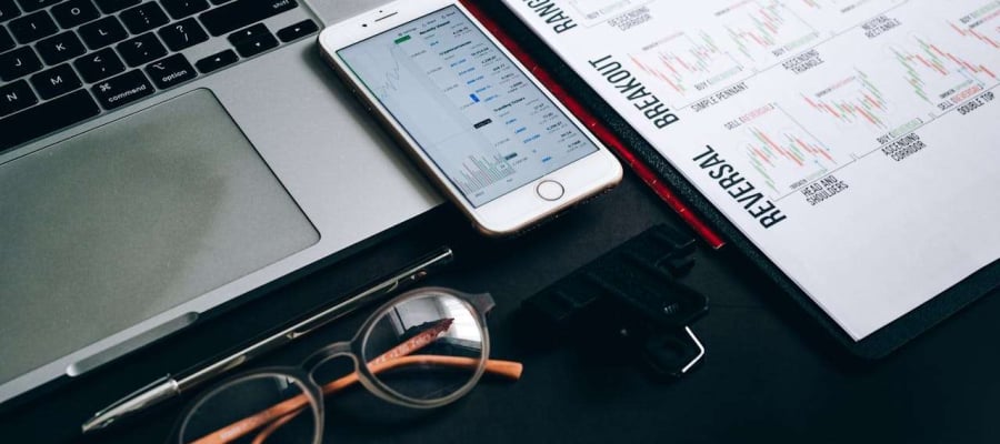 trading sheet phone laptop