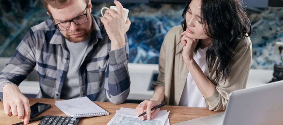 two people looking over paperwork