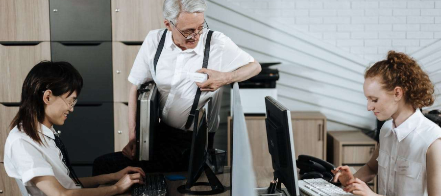 two people working while talking to their boss
