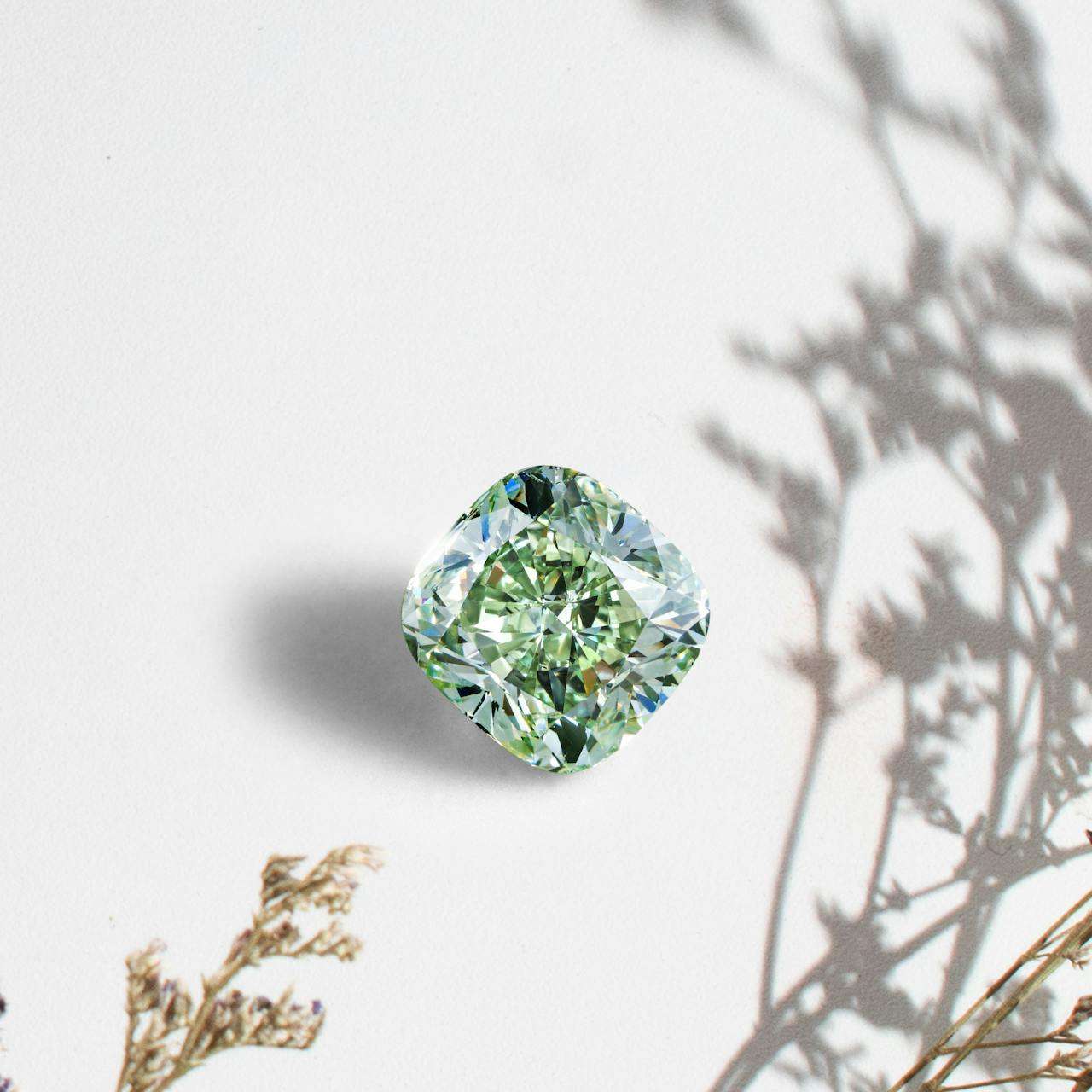 diamond gem stone on white surface