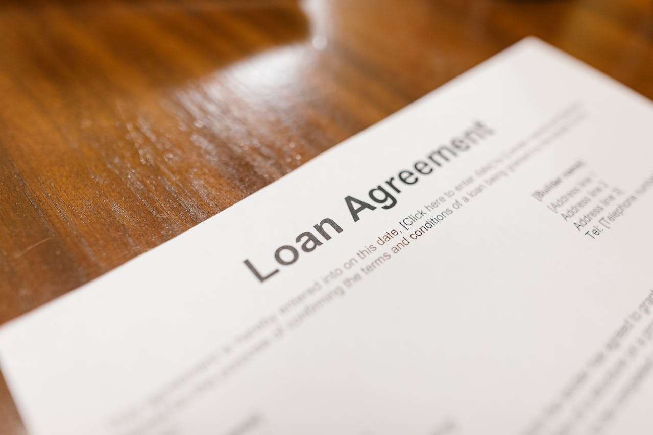 a loan agreement spread on a wooden table