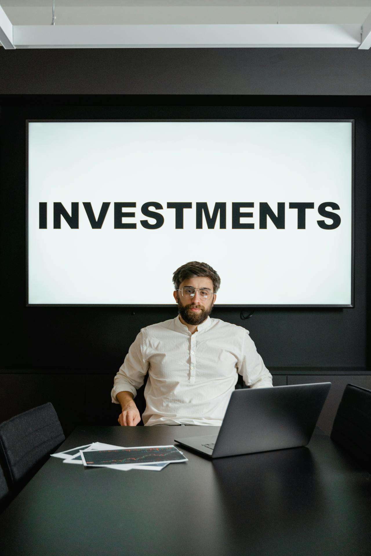a man giving a presentation about investments