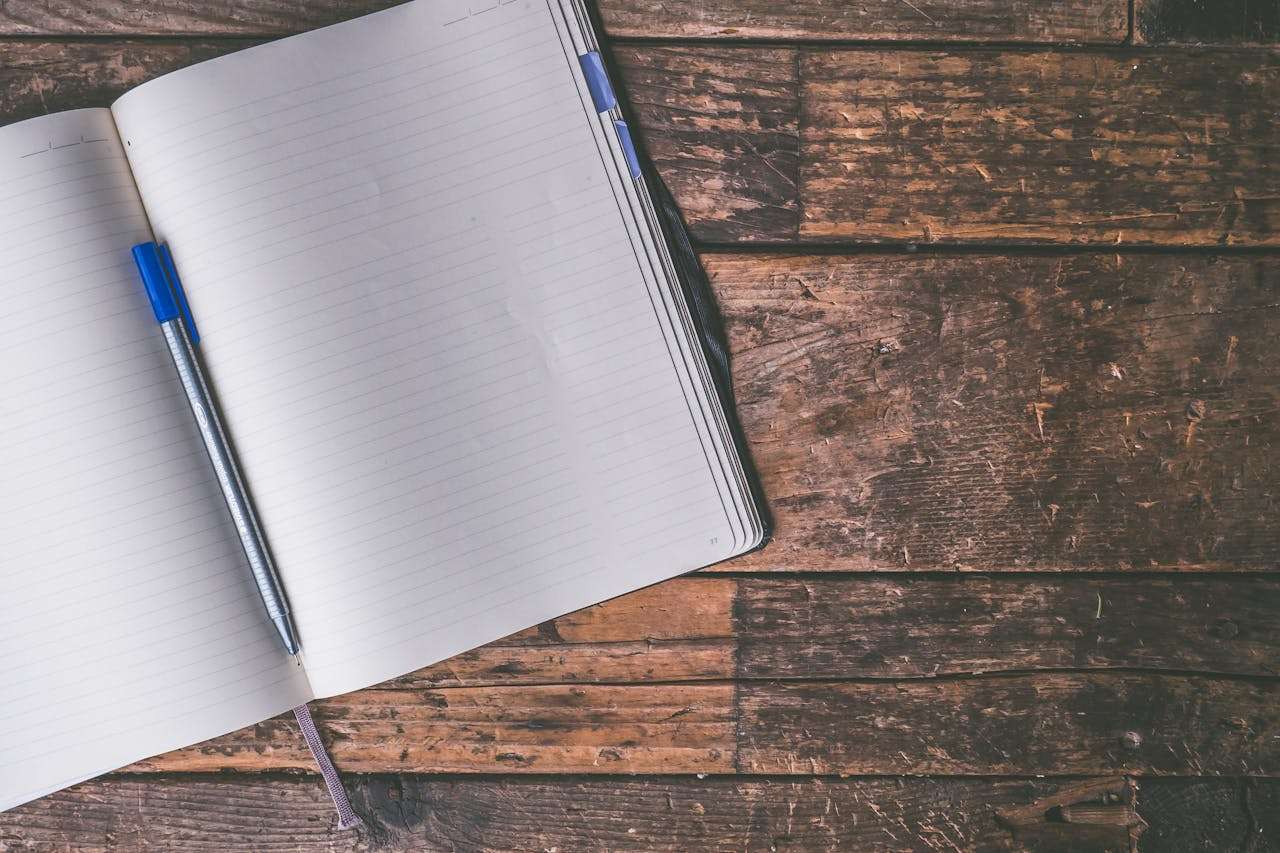 An open book on a wooden table.