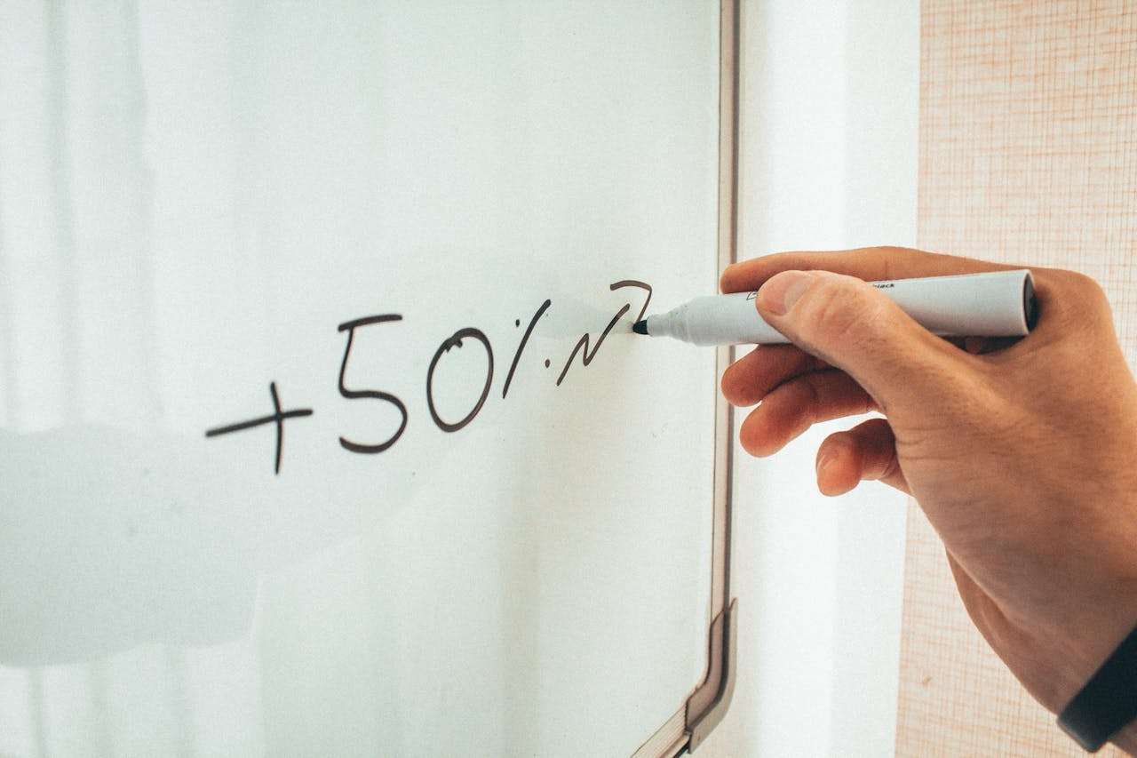whiteboard with a 50% sum