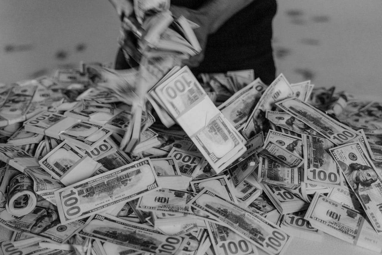 a person tipping out a pile of money