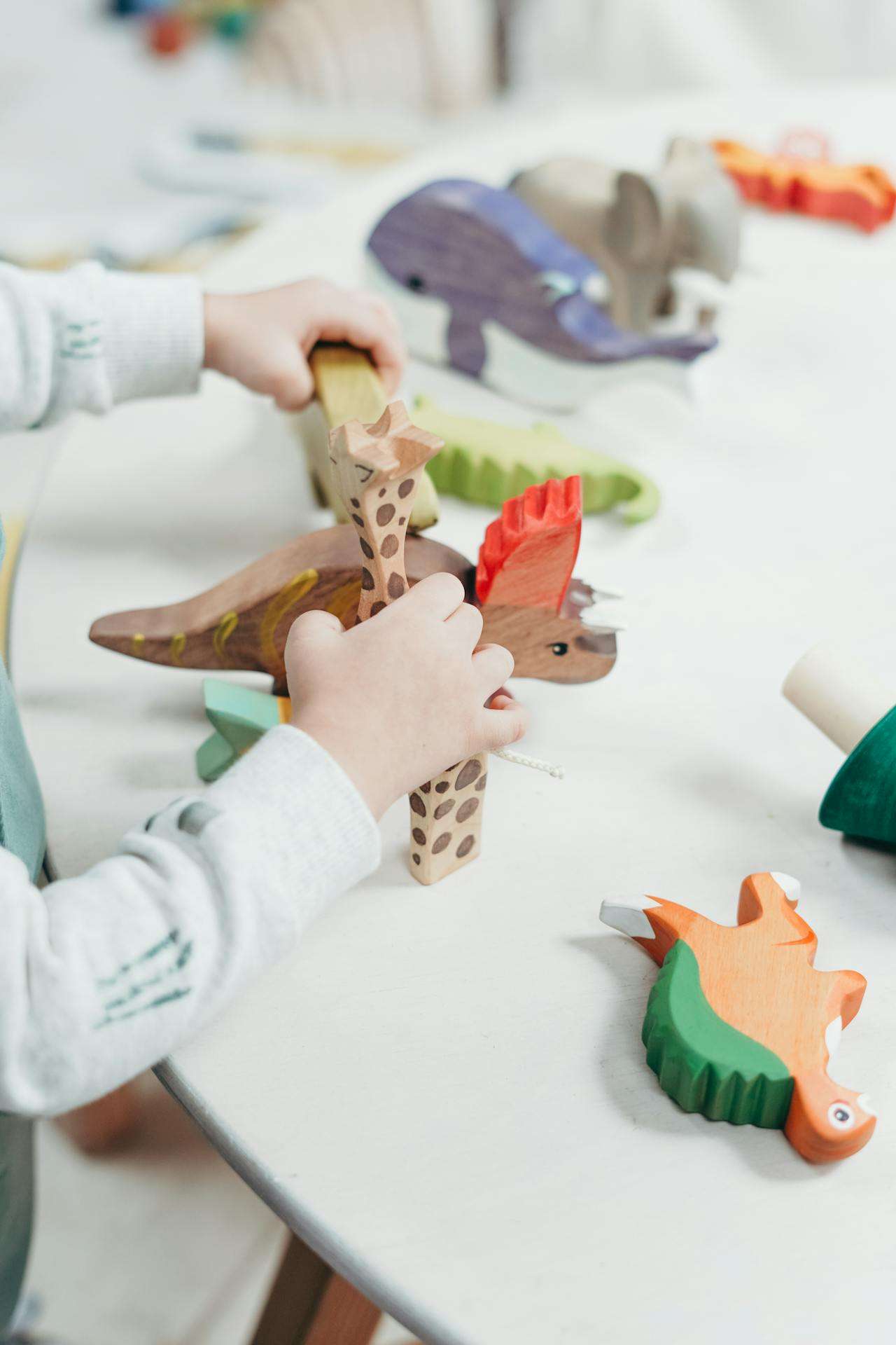 a child sitting on a table playing with toys