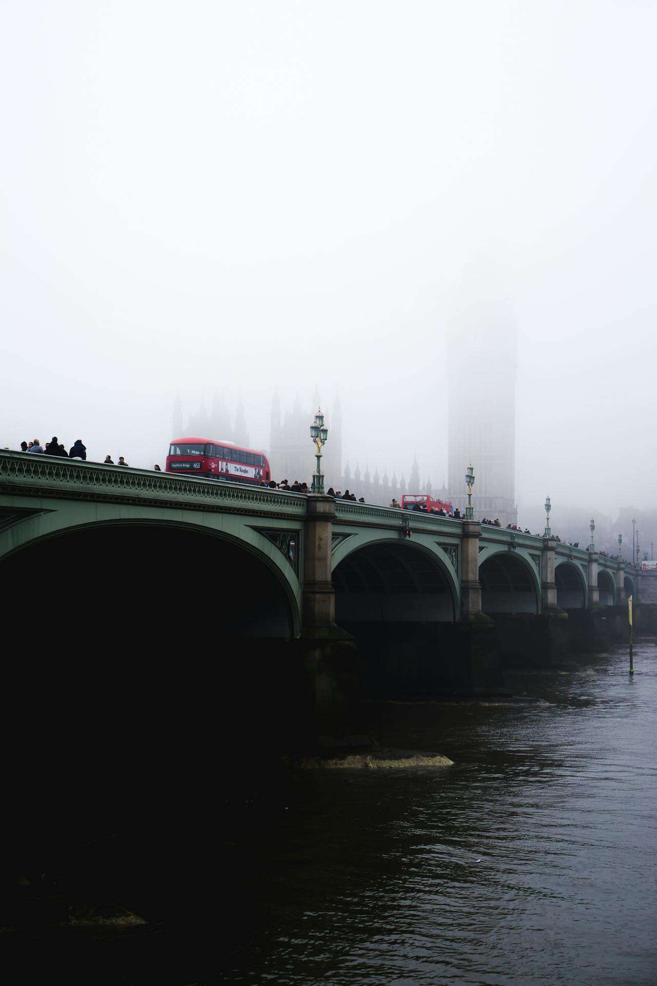 a foggy photograph of the london bridge