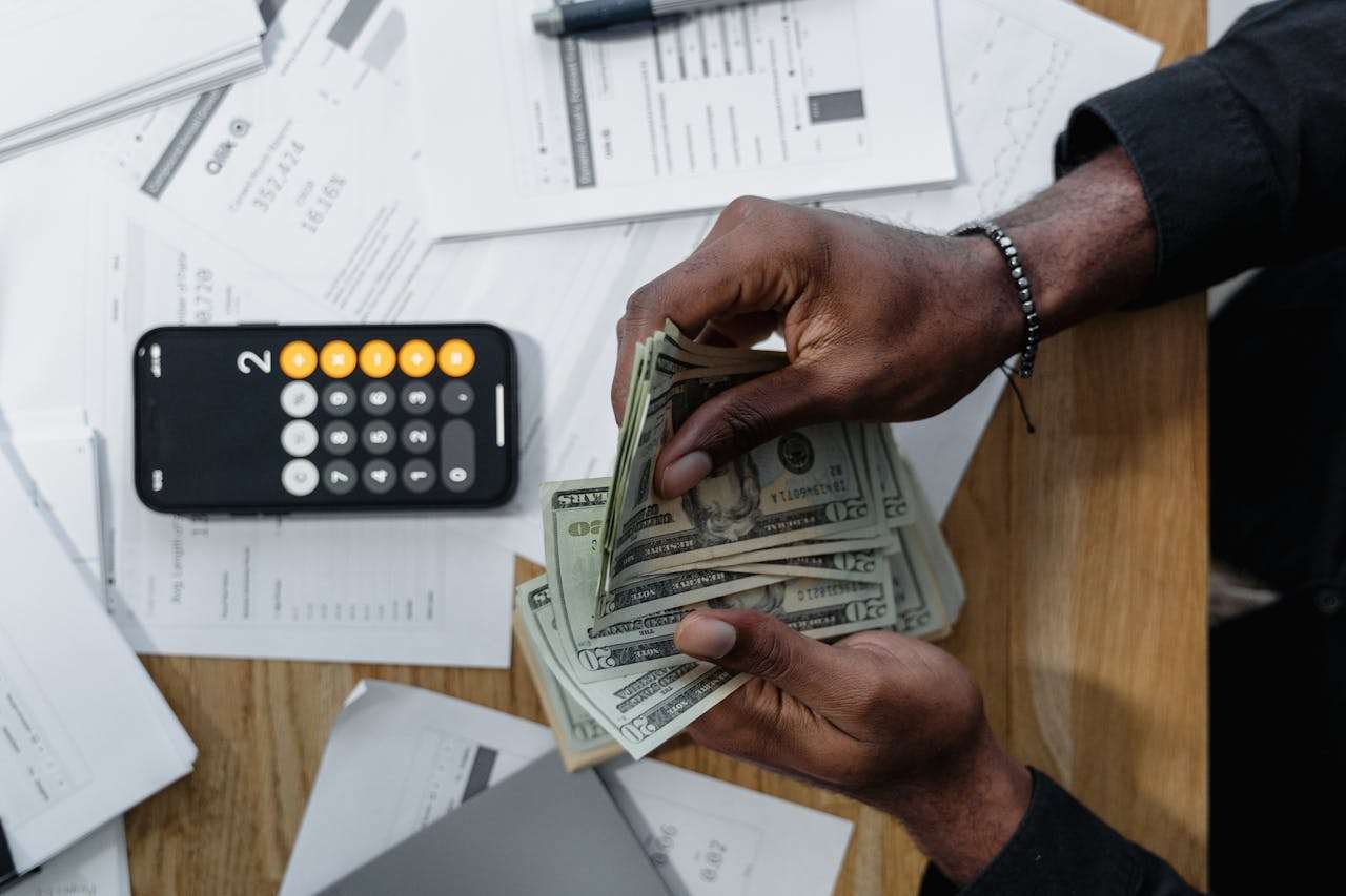 a man sitting at a desk counting money