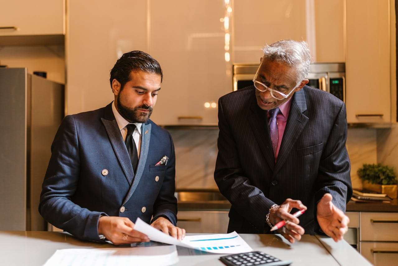 two people discussing charts