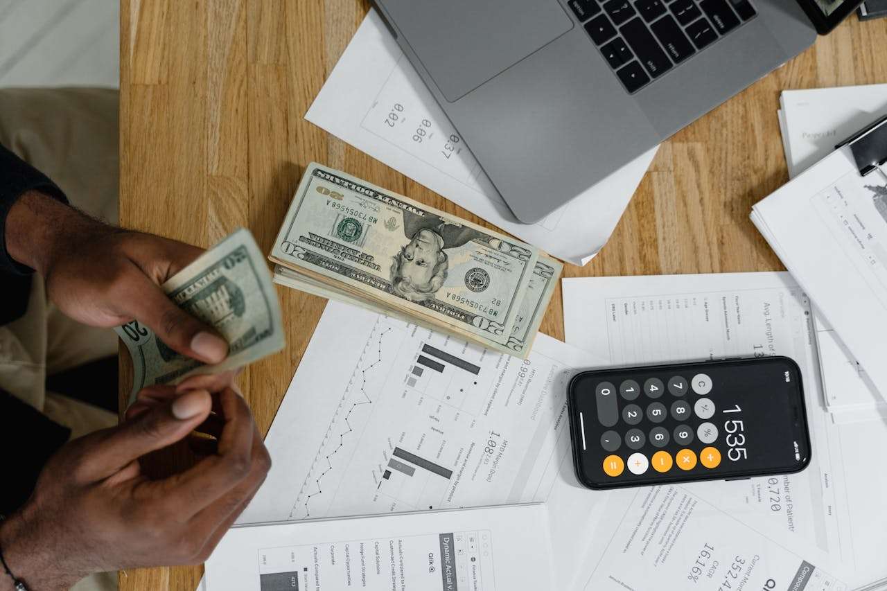 a person sat at a desk completing budgeting tasks