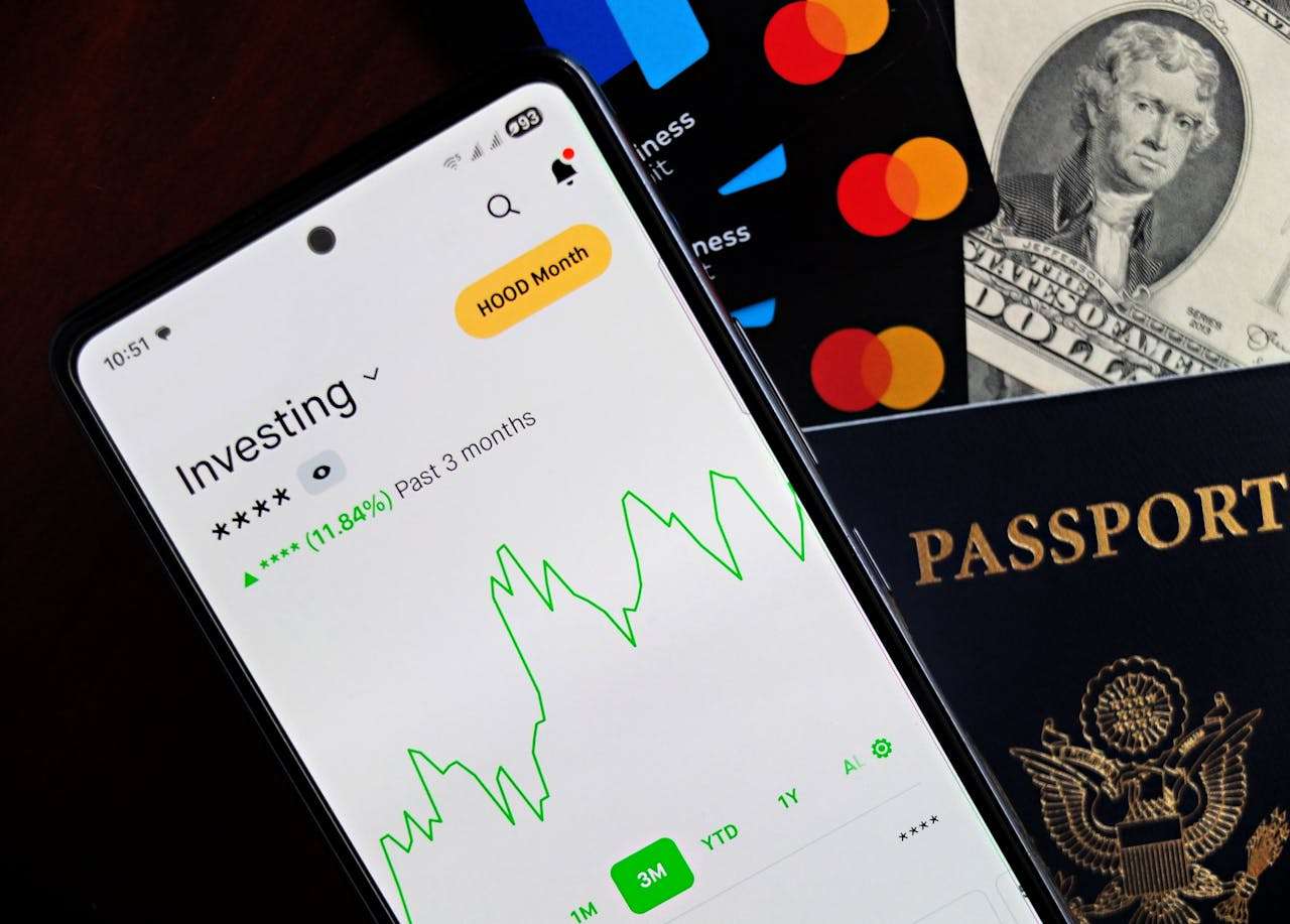 an image showing an investment fluctuating along with debit cards and passports.