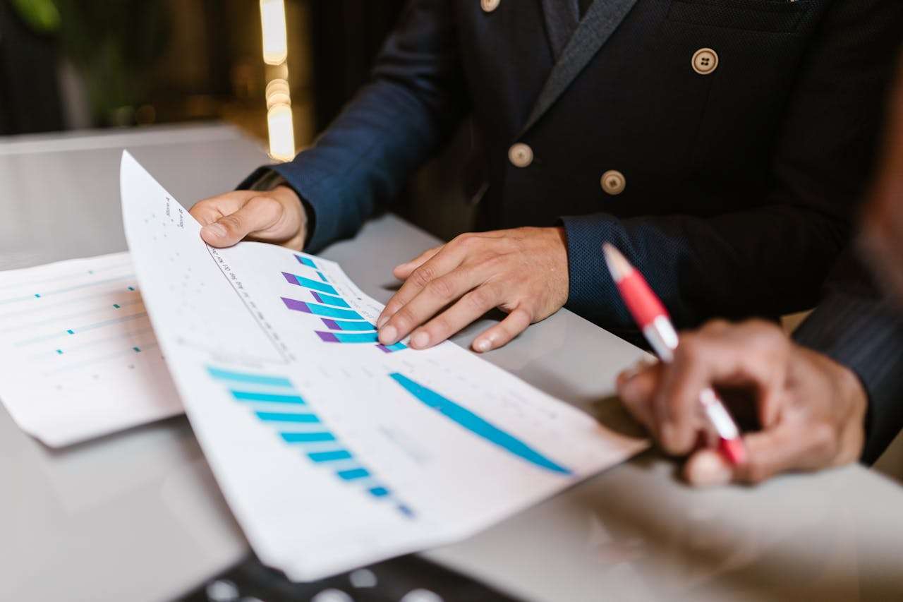 two people looking over investment graphs