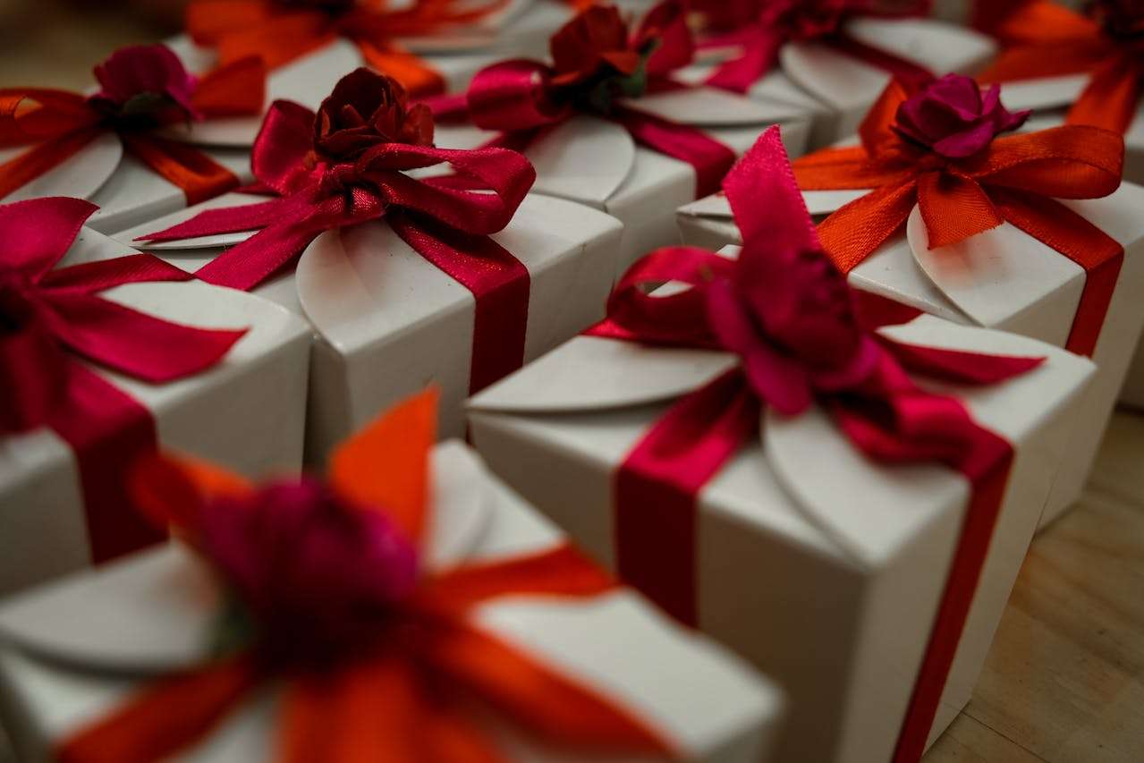a row of gifts with red ribbons