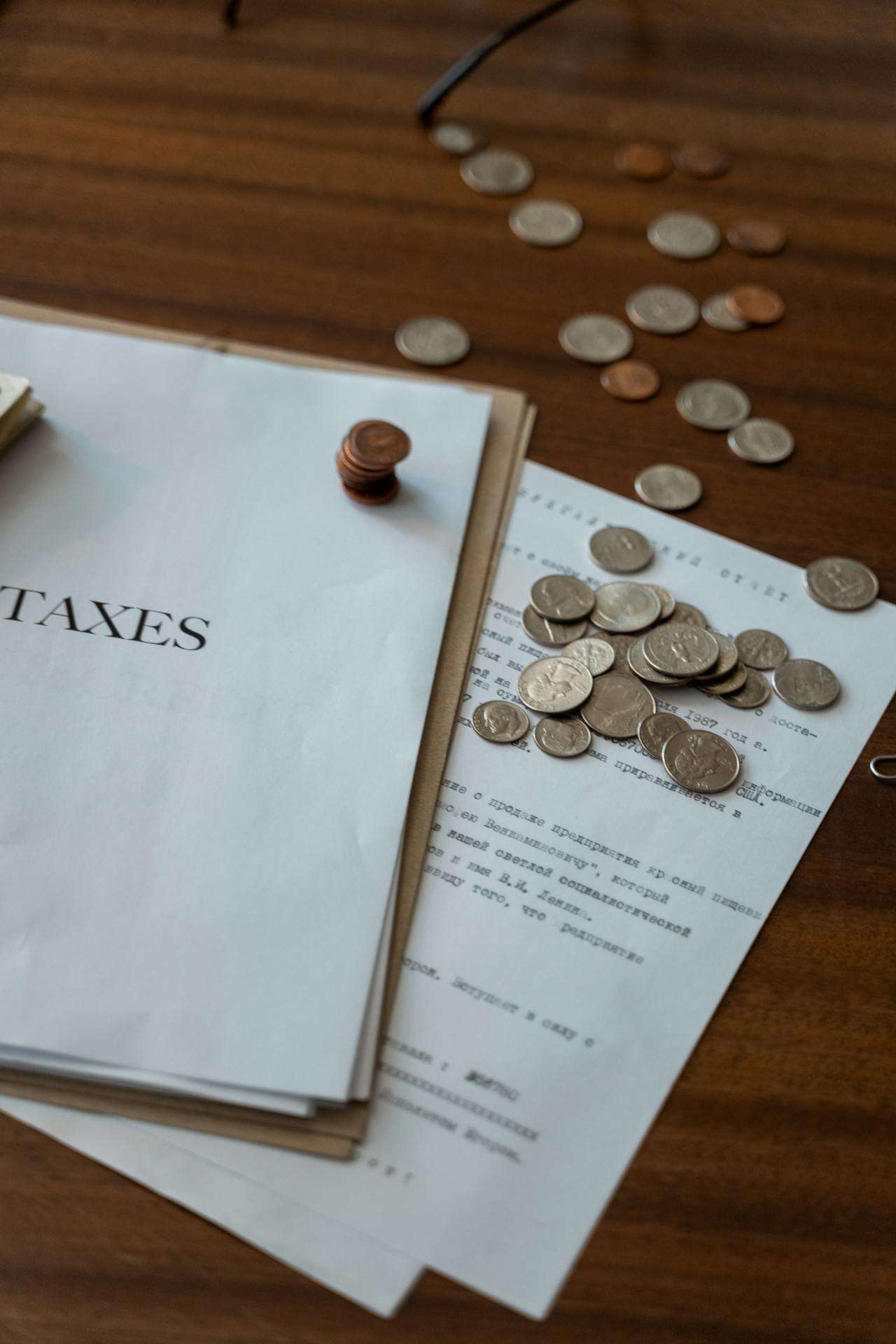 a sheet displaying "taxes" with coins off to the side