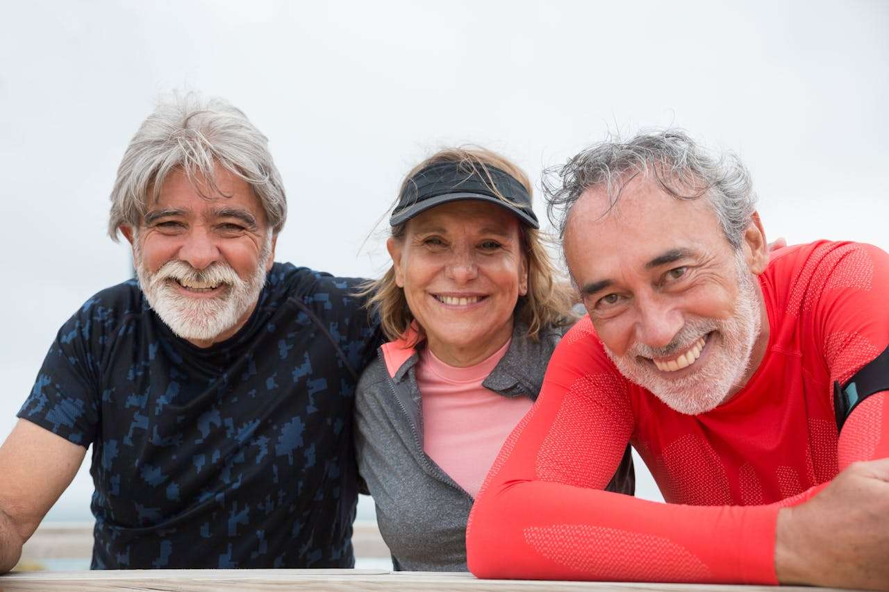 three retired people smiling