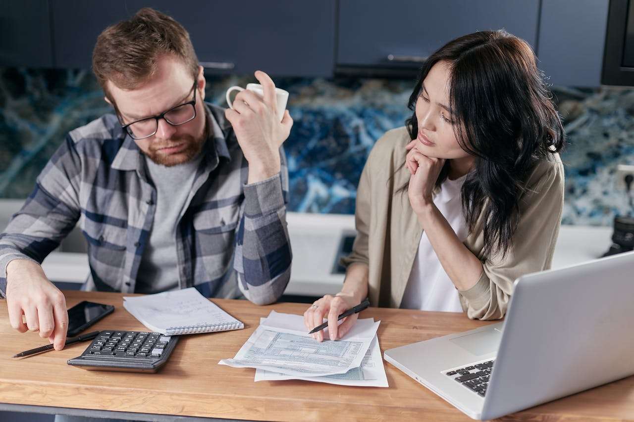 two people looking over paperwork