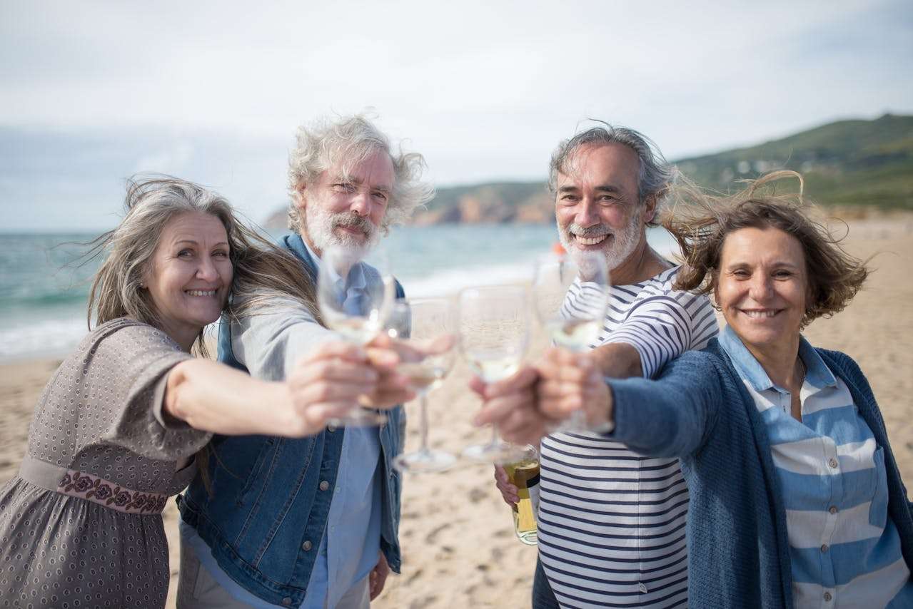 elderly people drinking wine by the sea