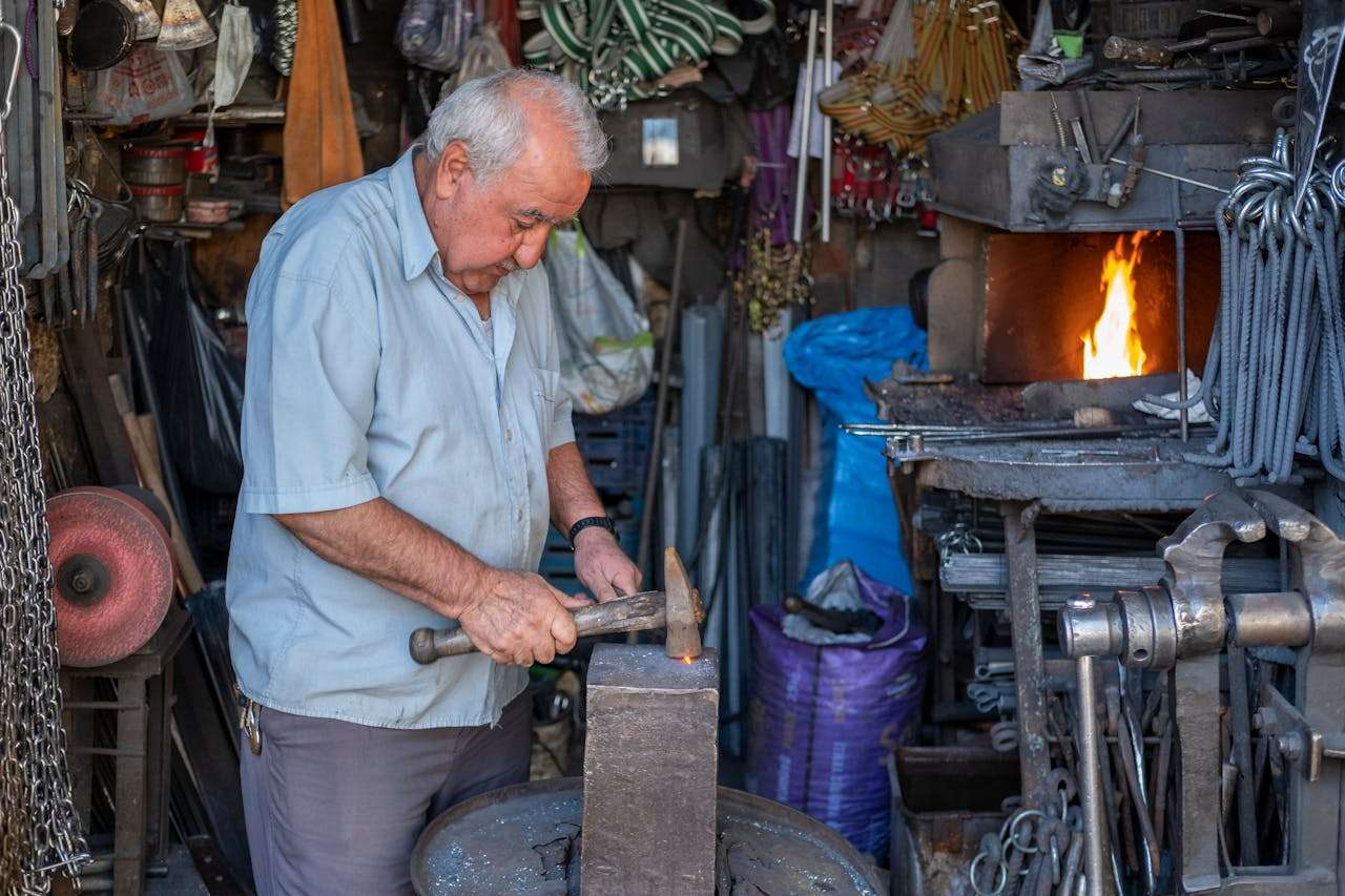 an older man still working. Blacksmithing work