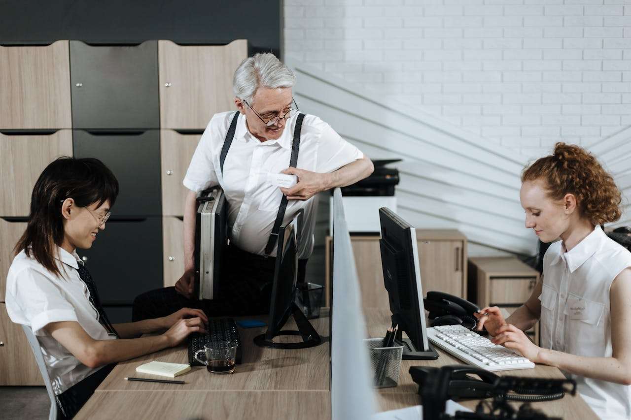 two people working while talking to their boss