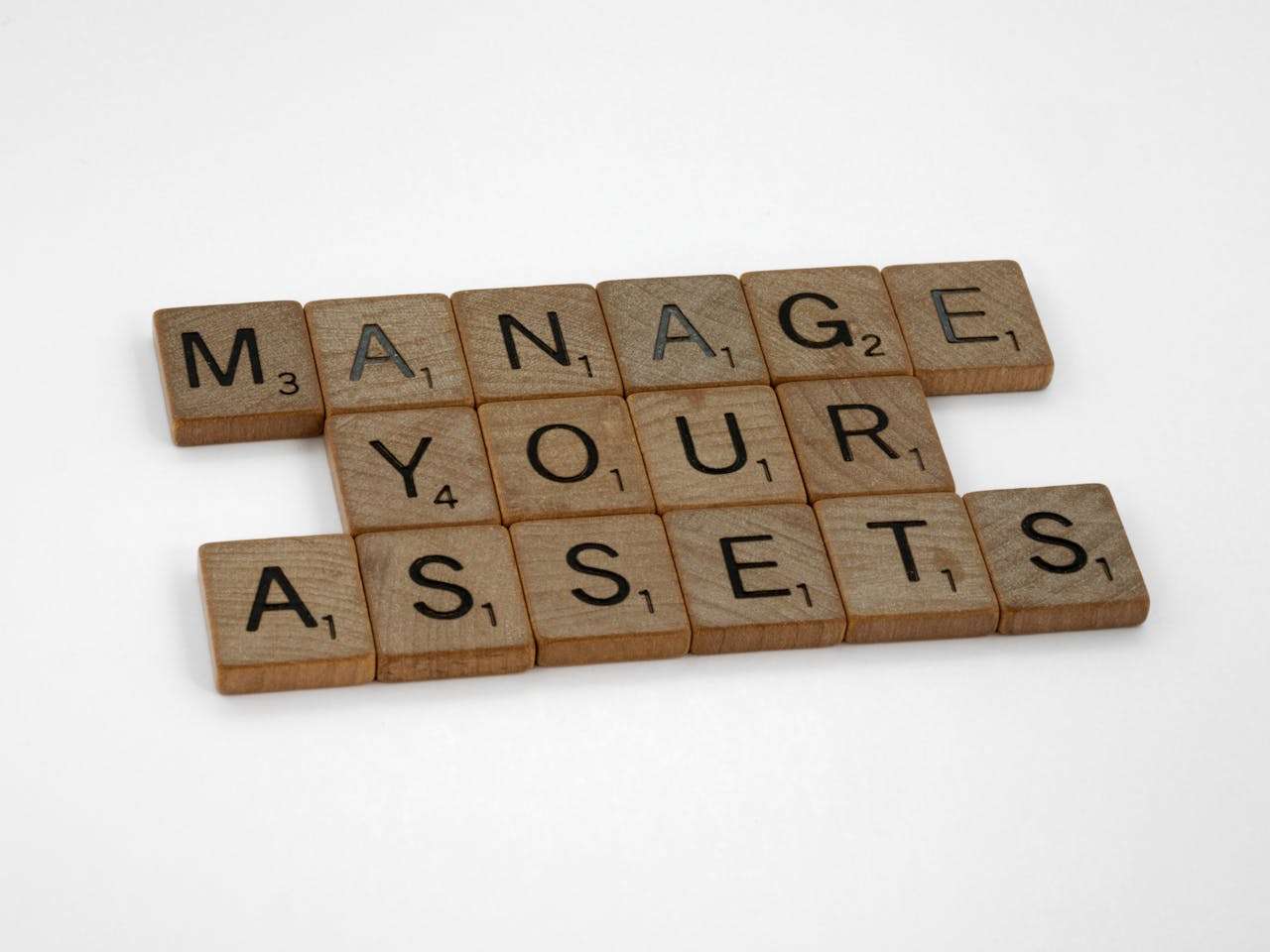Wooden blocks showing "Manage Your Assets"